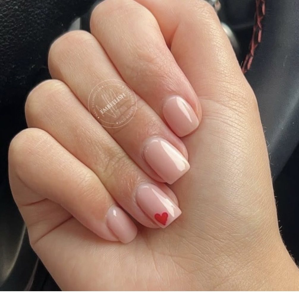 Nude nails with a tiny red heart